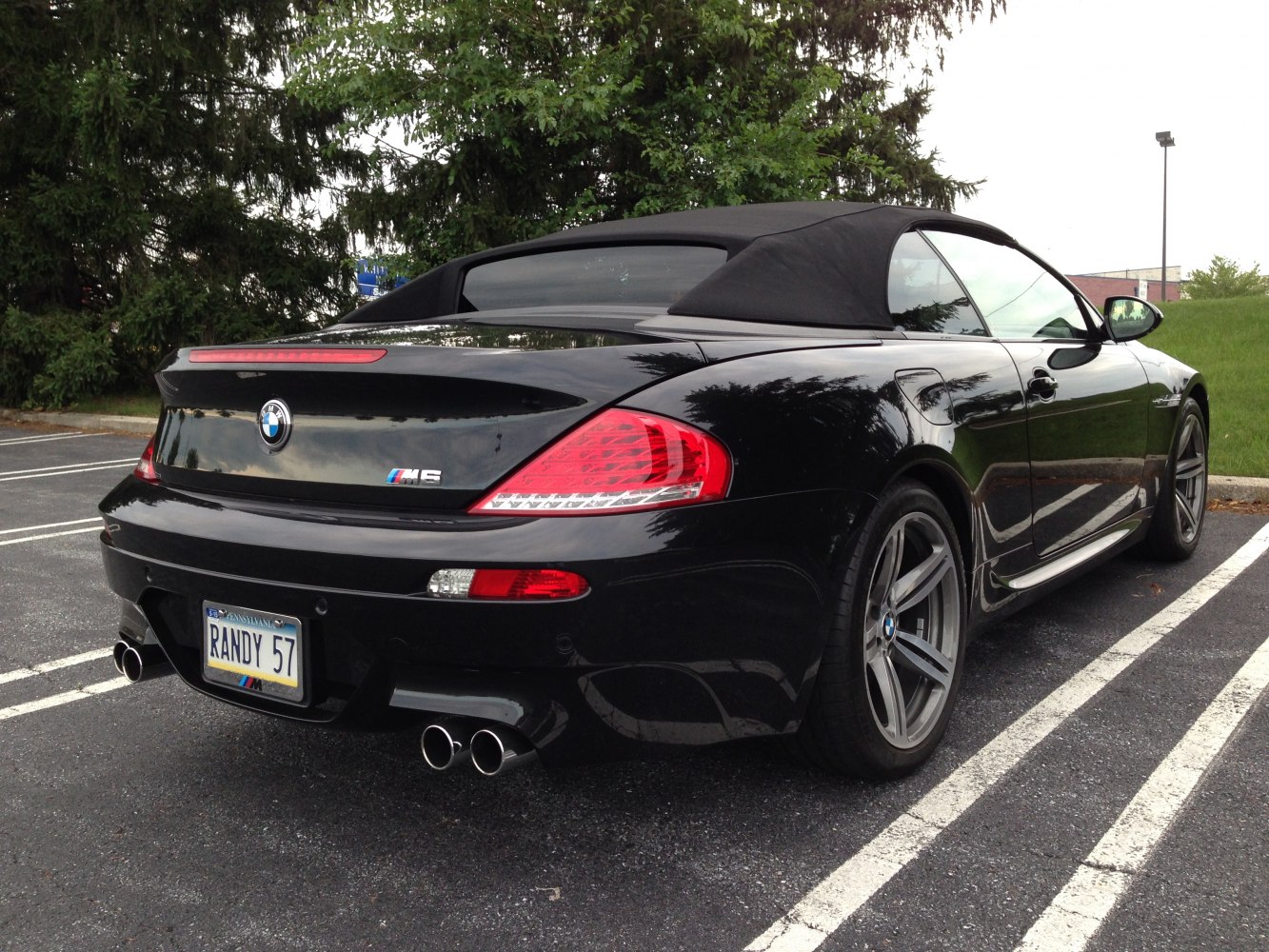 Black convertible rear exterior with quad exhaust and distinct tail lights