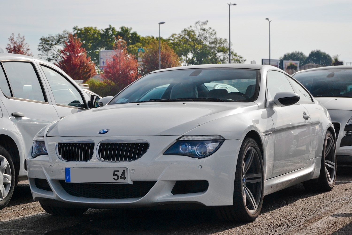 Front view of a white sports coupe with kidney grille and modern headlights.