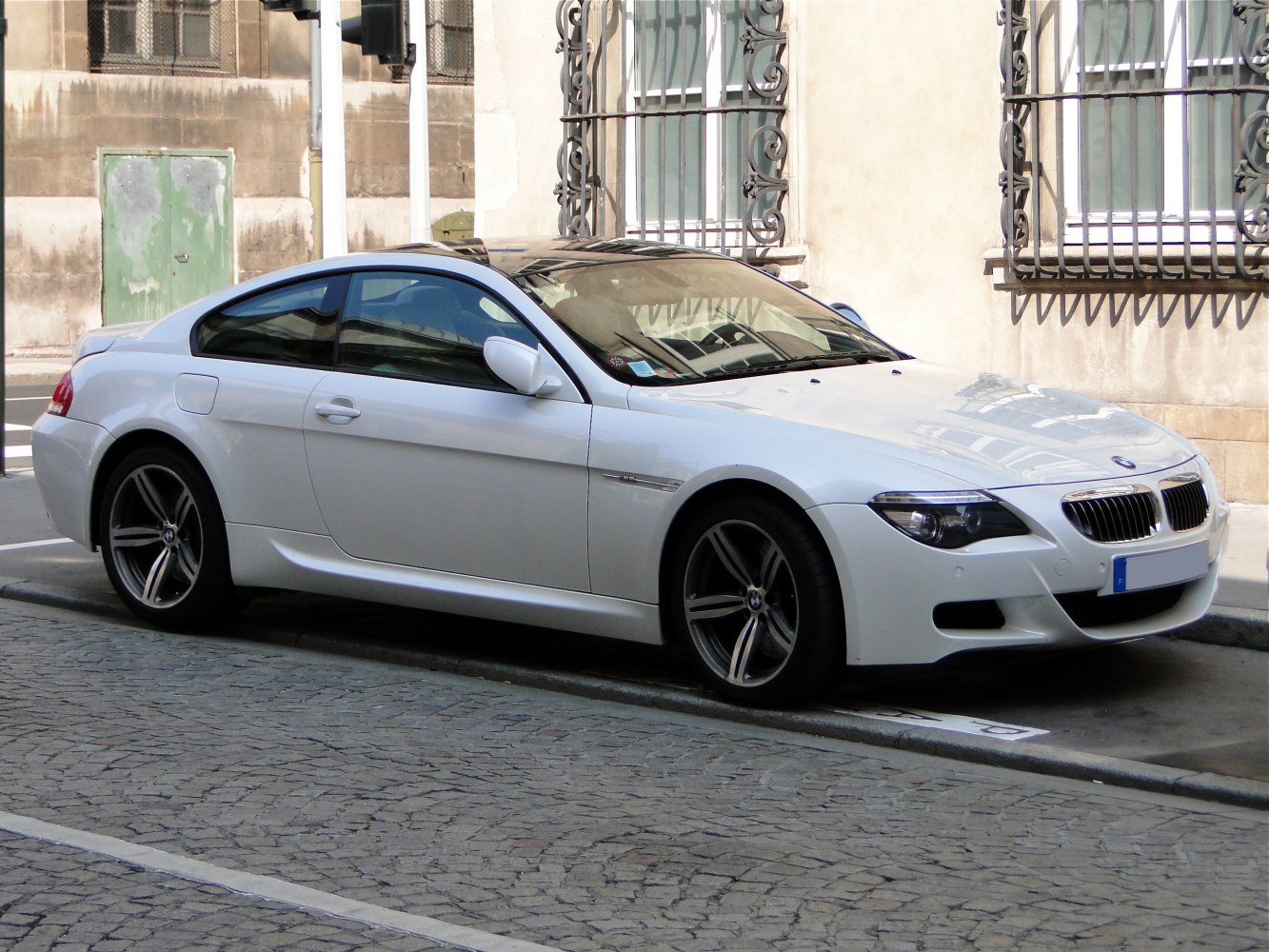 White coupe with sporty alloy wheels and sleek body design