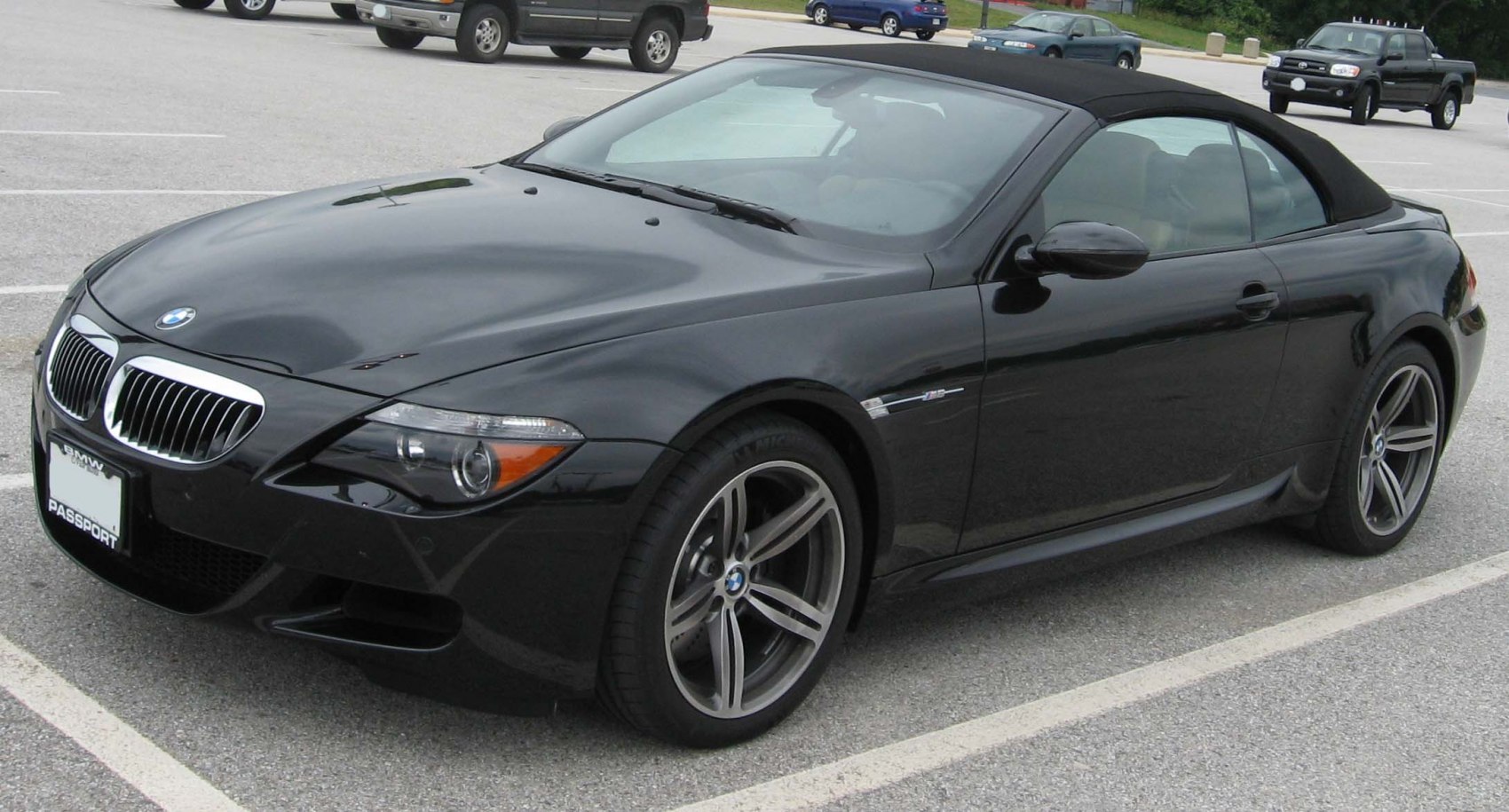Black convertible with soft top roof and alloy wheels