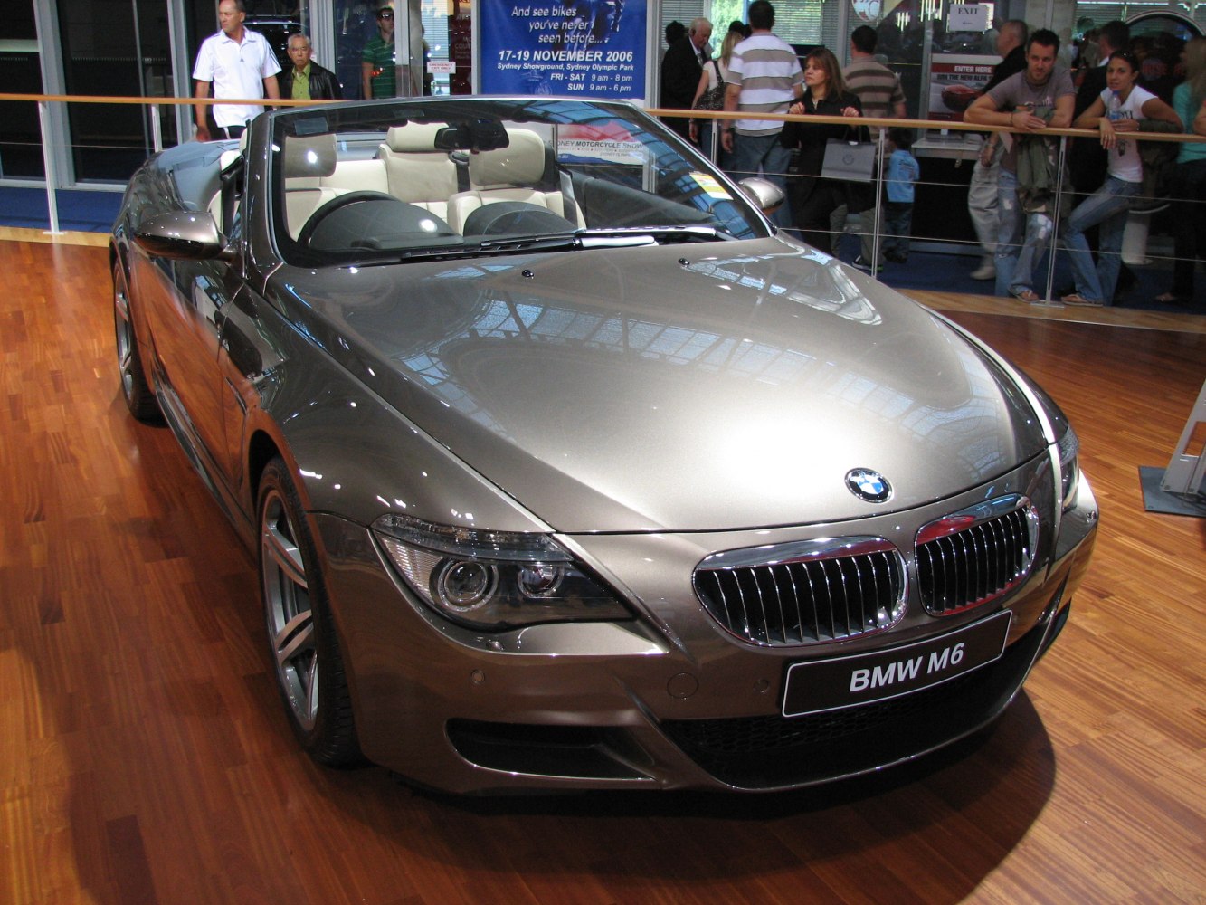 Convertible luxury sports car front with dual headlights and chrome grille