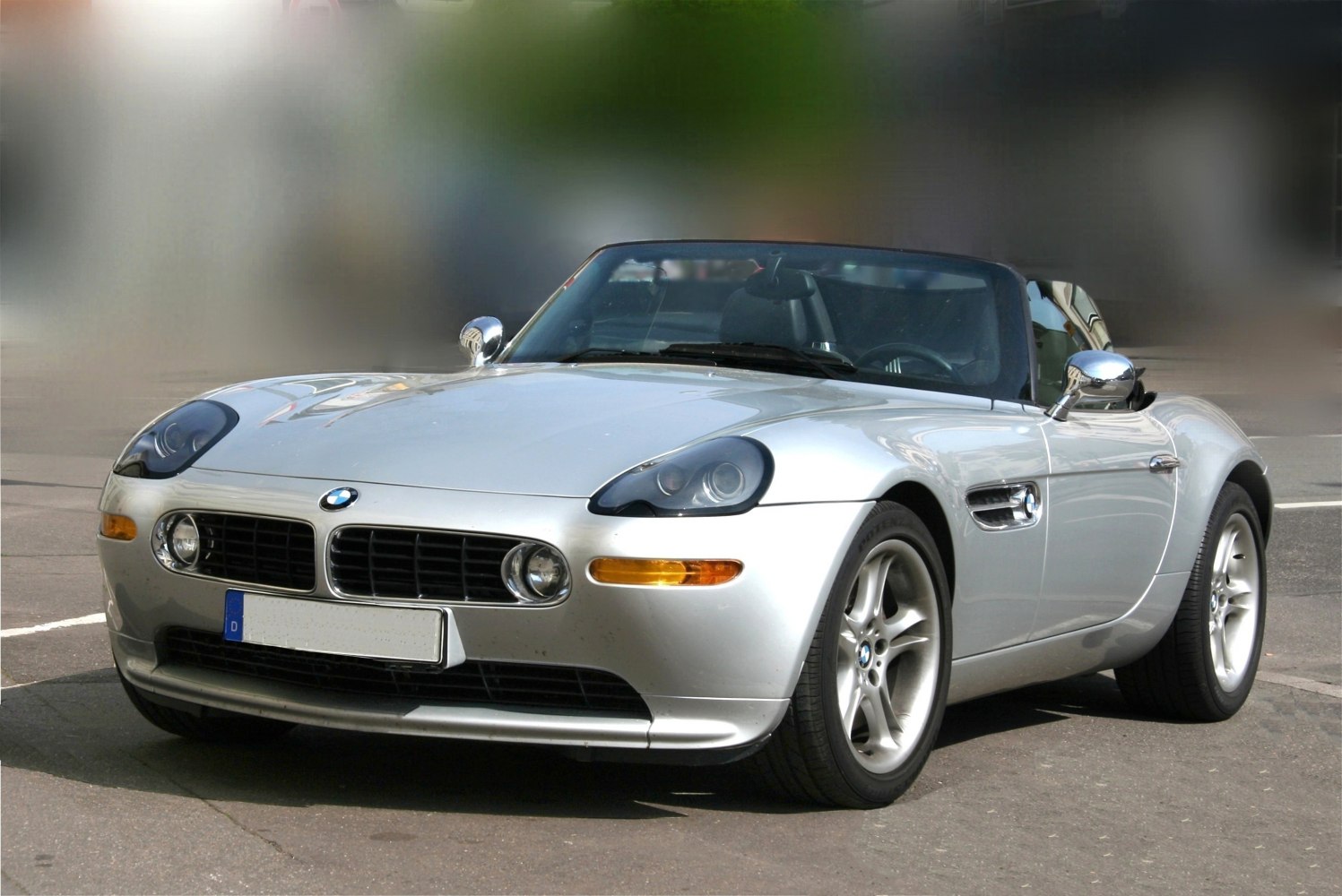 Convertible silver car with kidney grille and round headlights