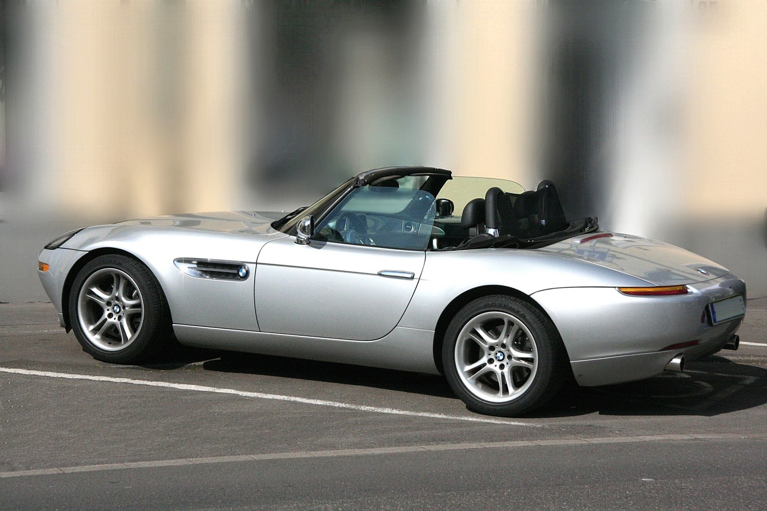 Silver convertible roadster with rounded rear and side vents