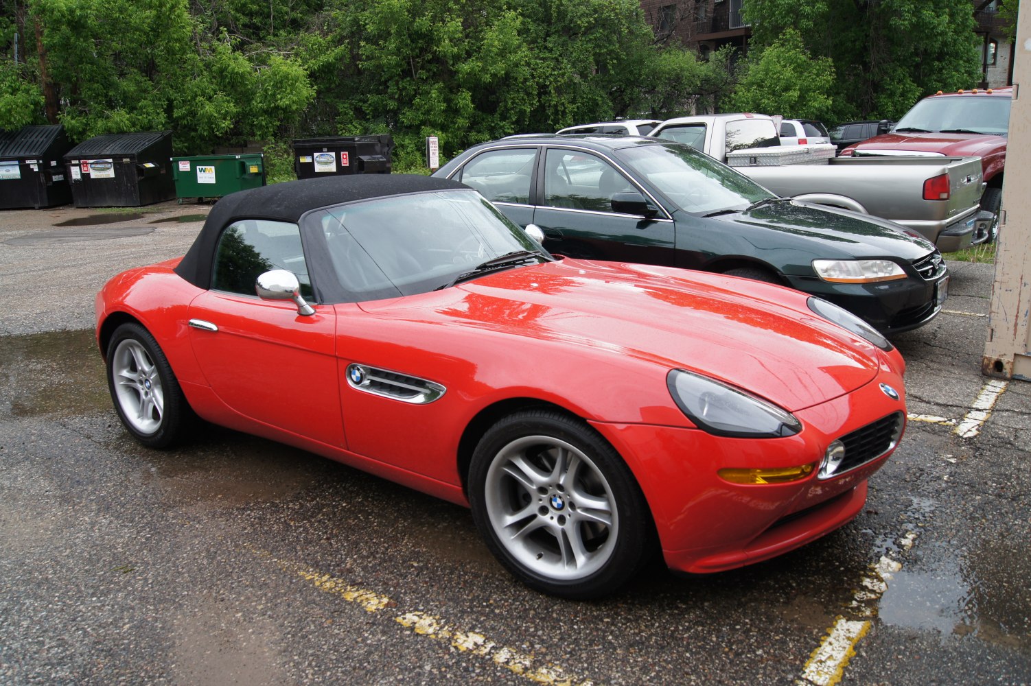 Red convertible roadster with soft black top and silver alloy wheels