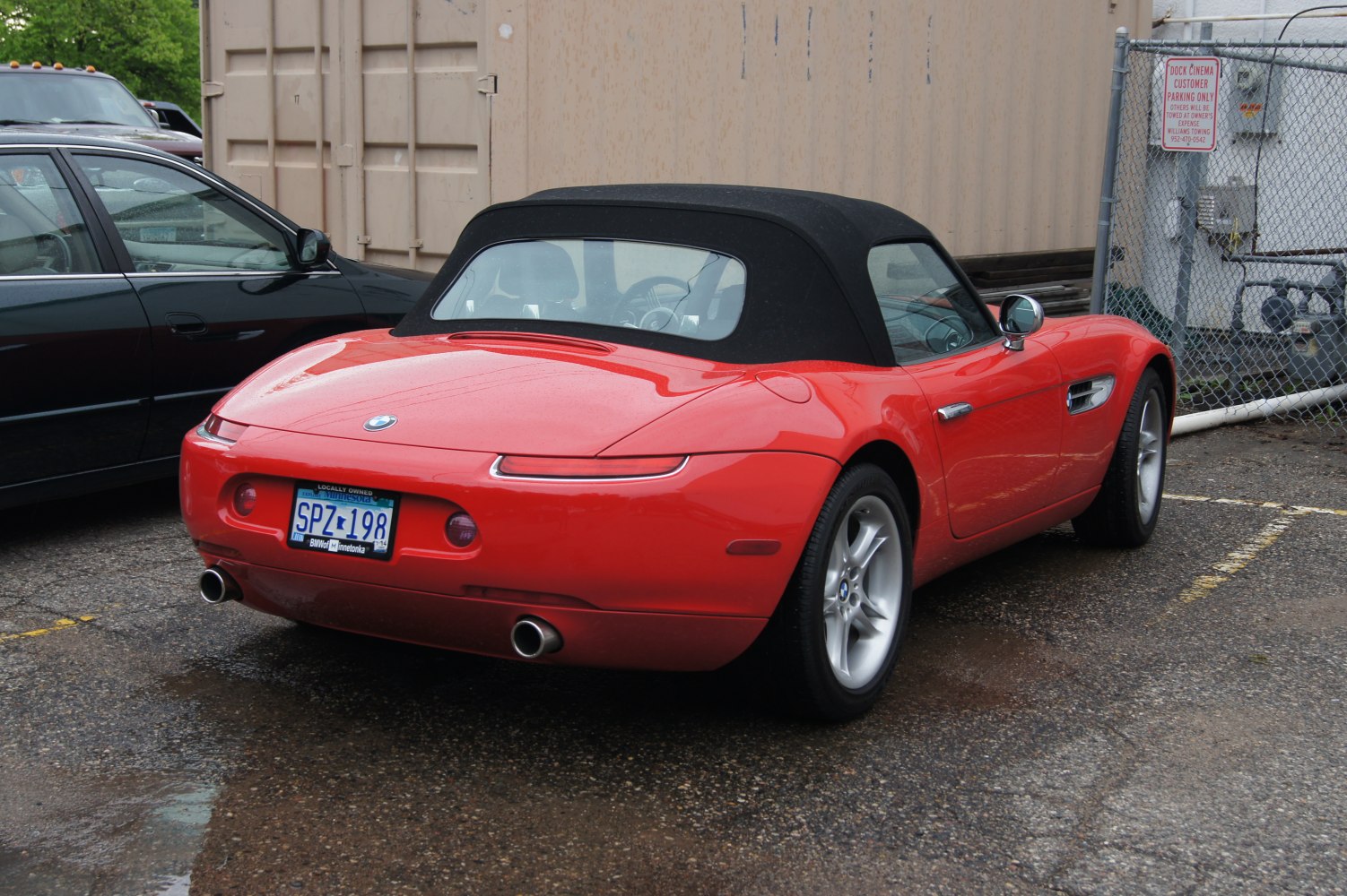 Convertible soft top rear view with tail lights and dual exhaust pipes