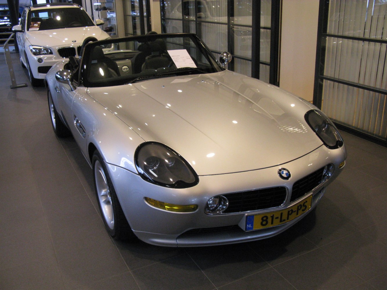 Front view of convertible roadster with distinctive headlights and aerodynamic body