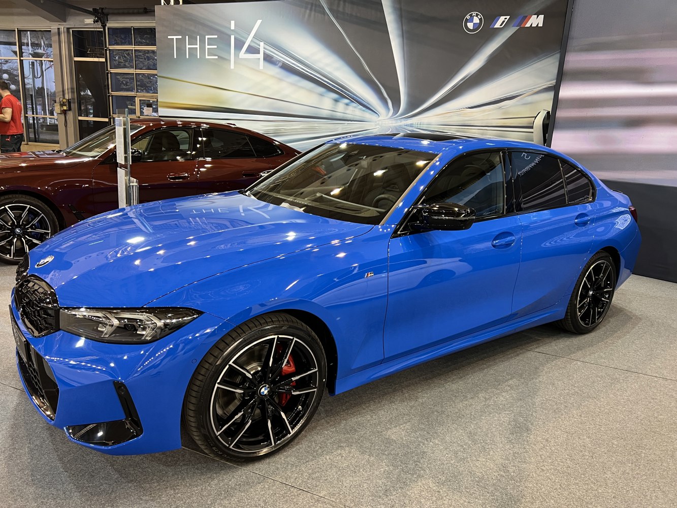 Blue sporty sedan with black alloy wheels and sleek modern design