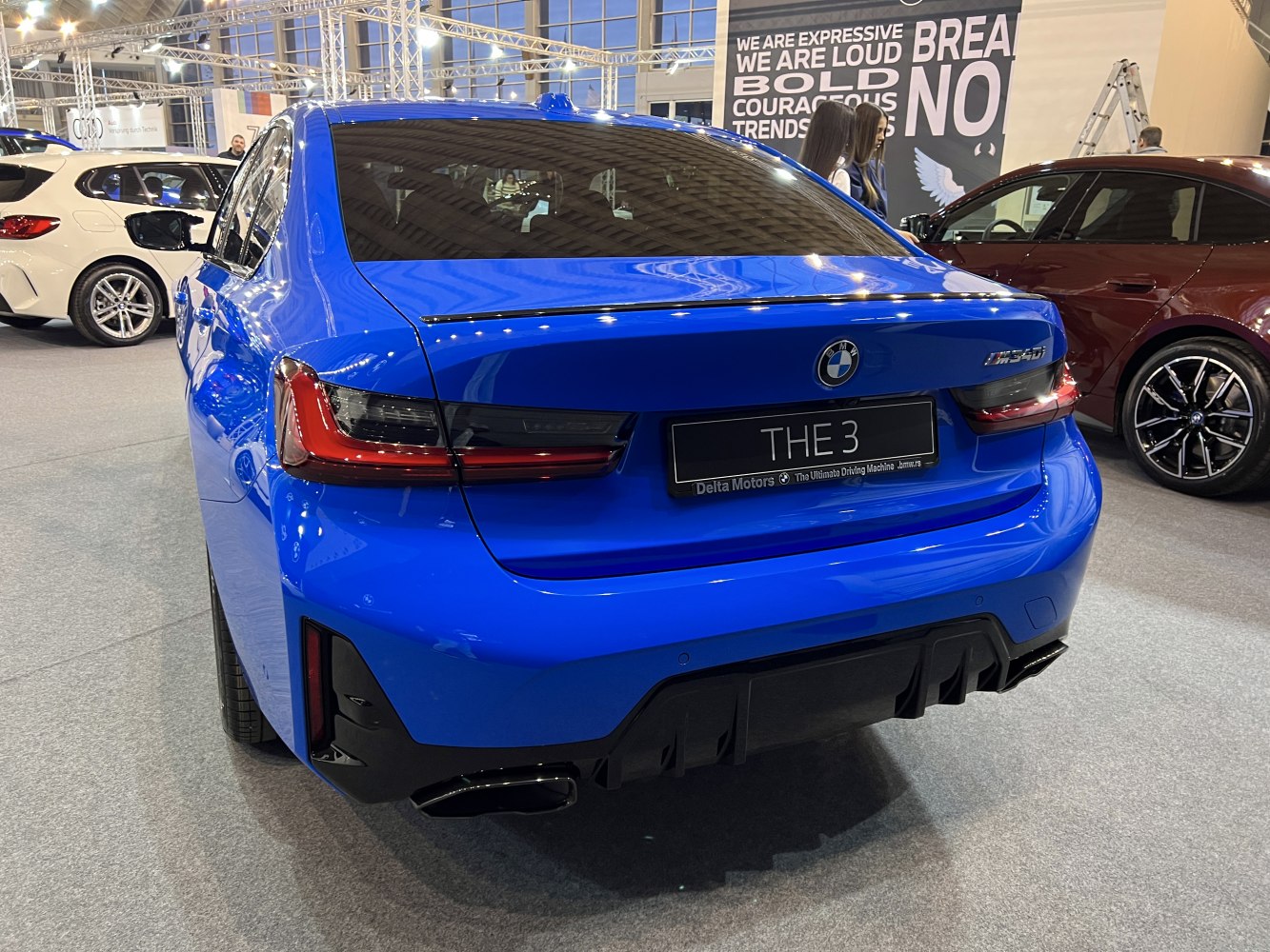 Blue sedan rear with LED taillights and dual exhaust outlets