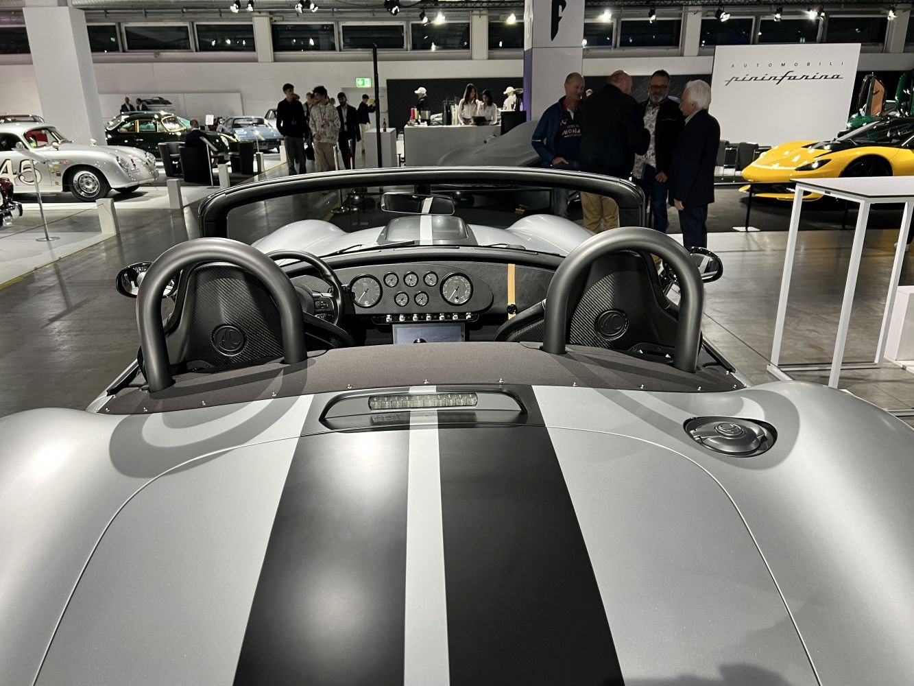 Twin roll hoops and racing stripes on a convertible roadster interior.
