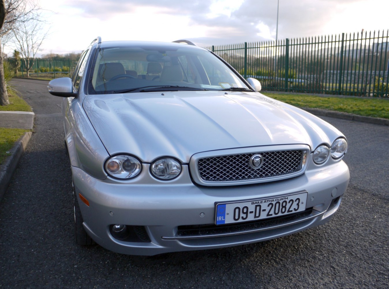 Front view with chrome mesh grille and quad round headlights of an estate car