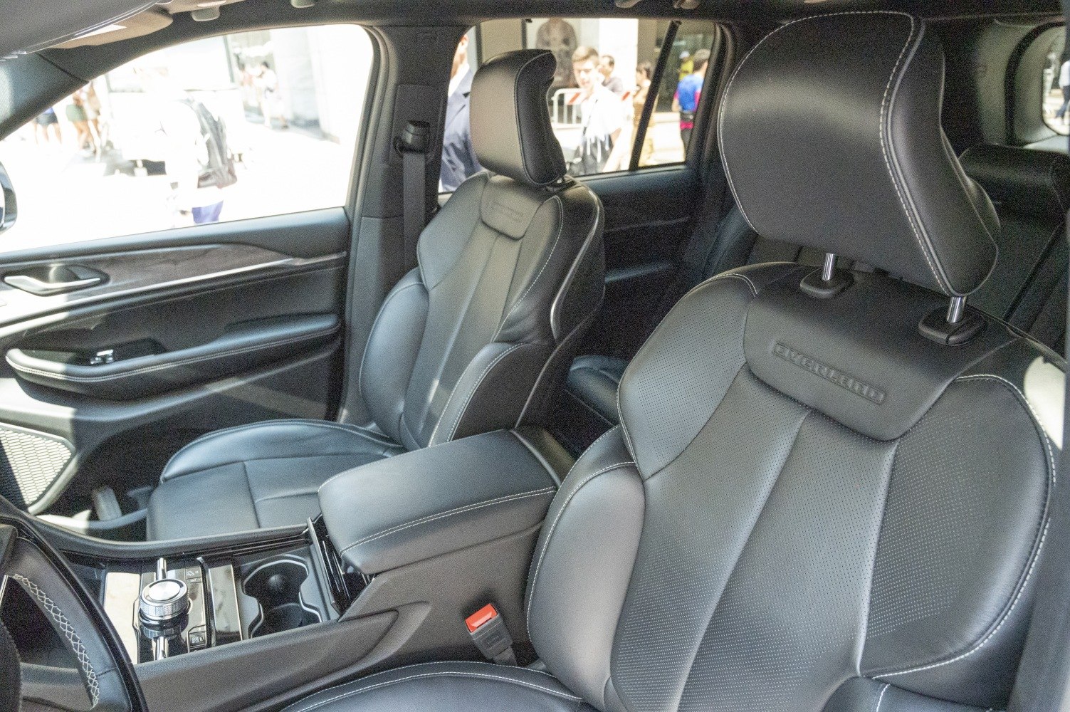 Black leather perforated seats with stitching and center console