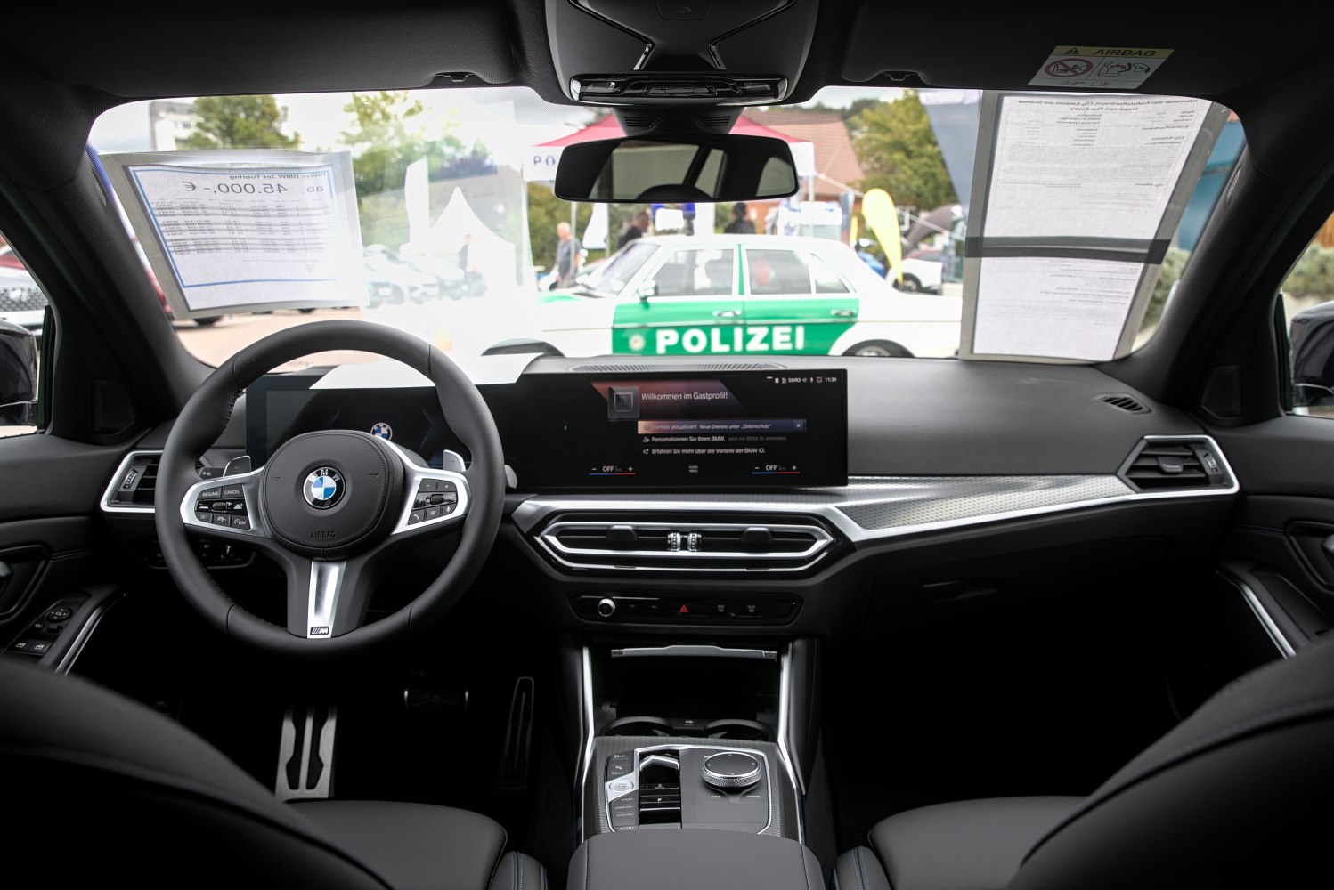 Modern BMW dashboard with digital displays and multifunctional steering wheel