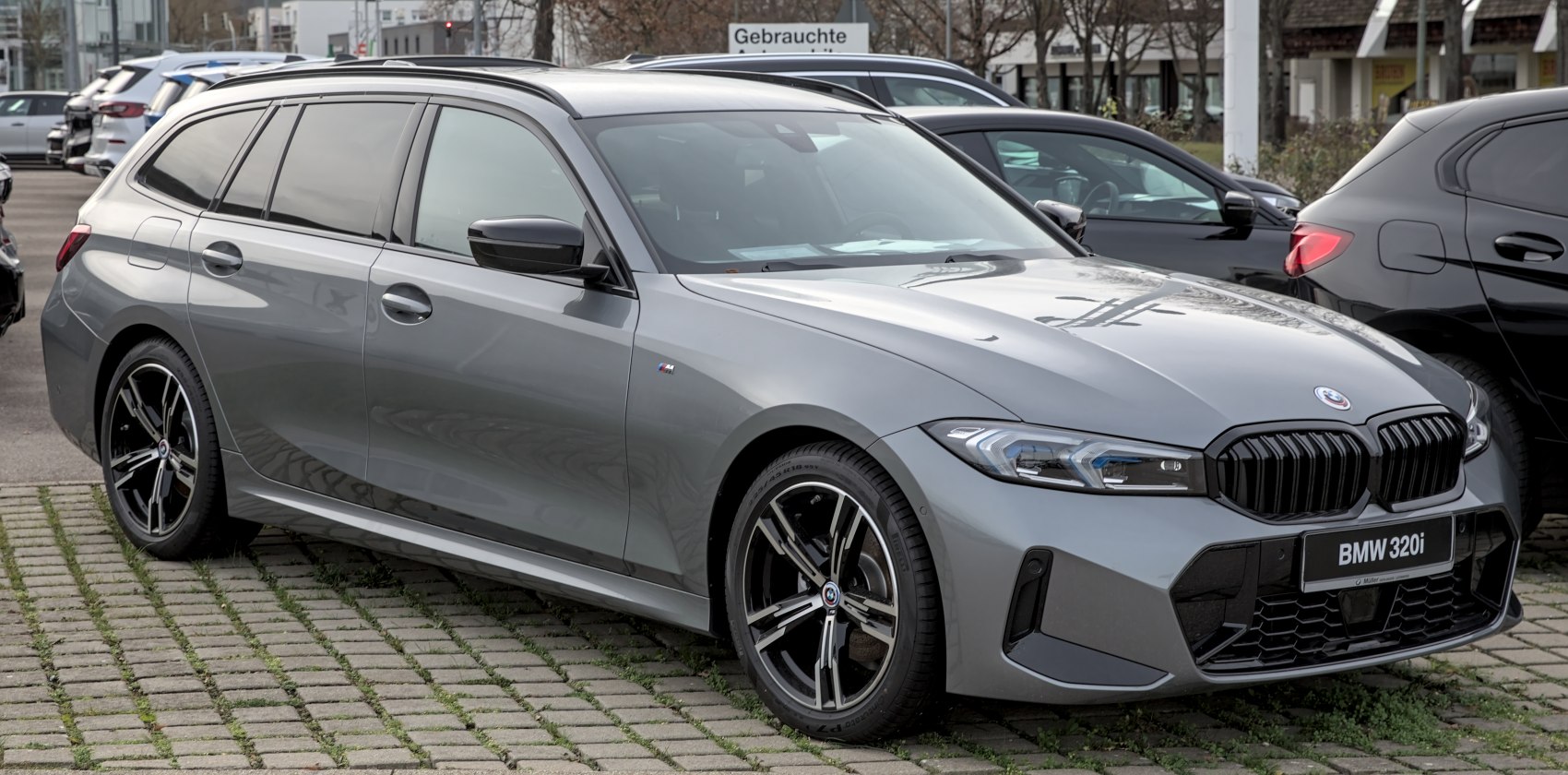 Gray station wagon with black grille, roof rails and alloy wheels