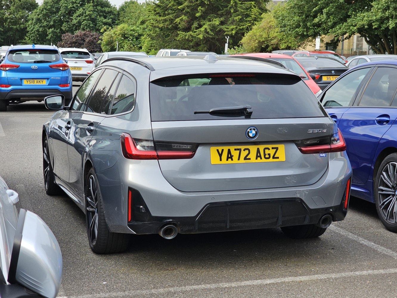 Rear view of a modern station wagon with dual exhaust and roof rails.