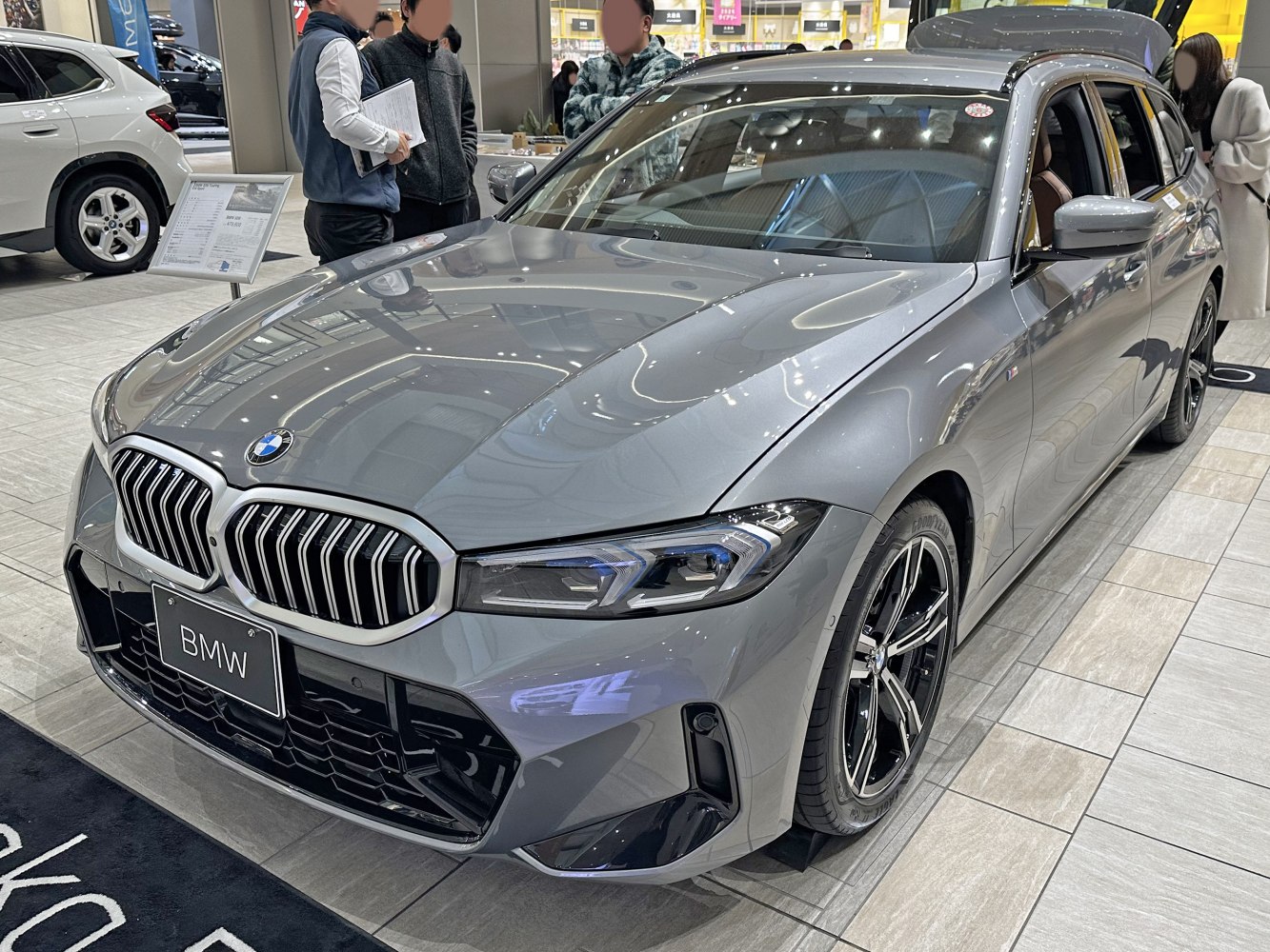 Front view of silver BMW 3 Series Touring with kidney grille and LED headlights
