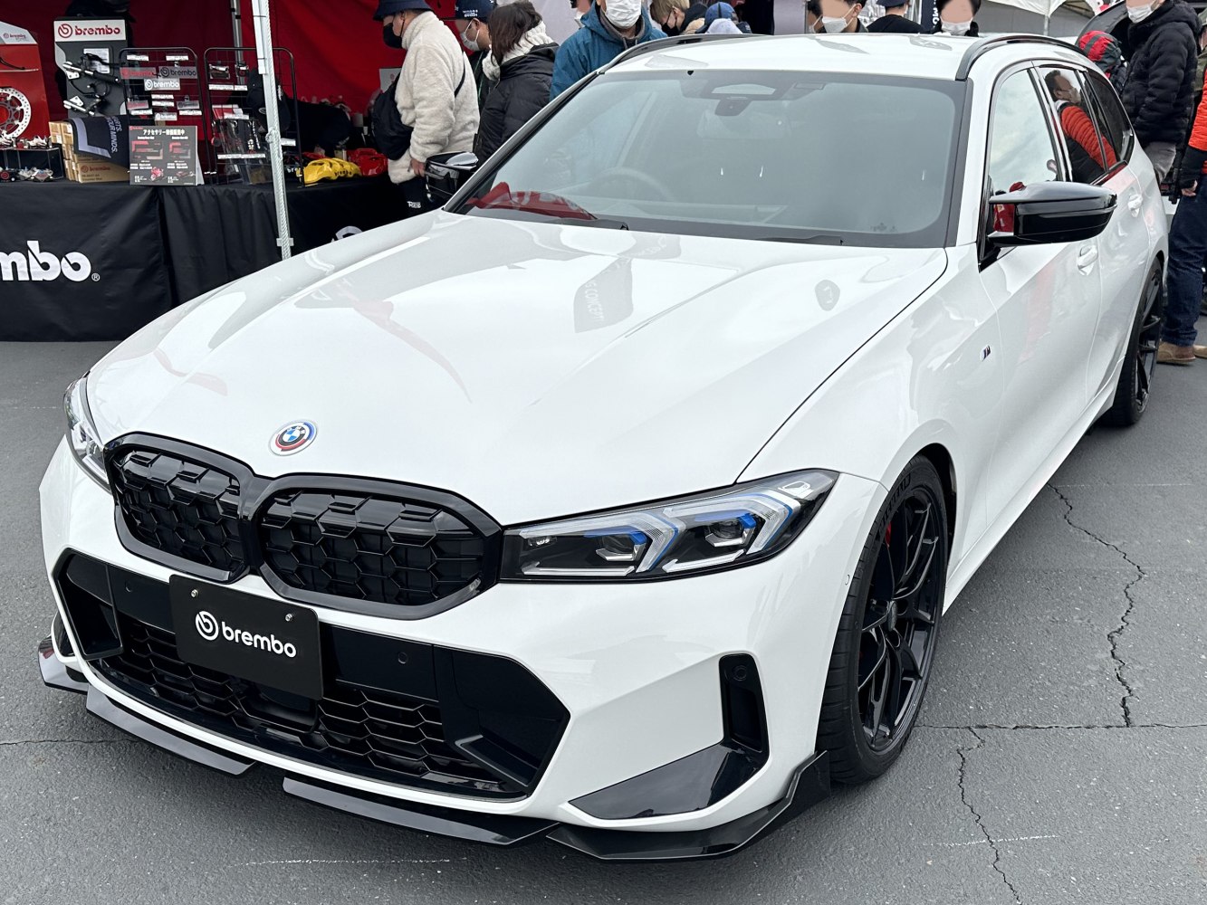 Front grille and headlights of a white sports wagon with black accents.