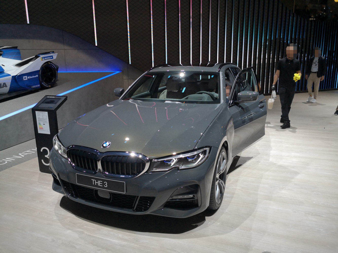 Front view of station wagon with open door and modern headlights