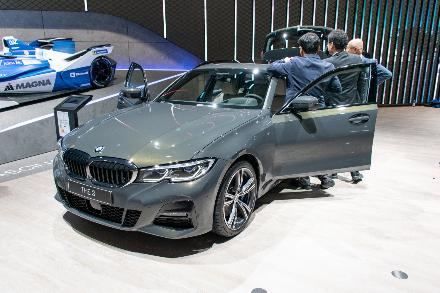 Front view of a sporty mid-sized sedan with open doors