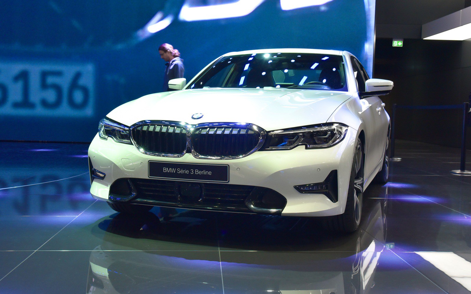 Front view showcasing kidney grille and LED headlights in showroom lighting