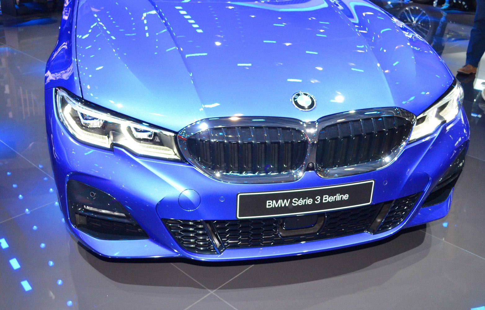 Close-up of front grille and LED headlights on a blue sedan