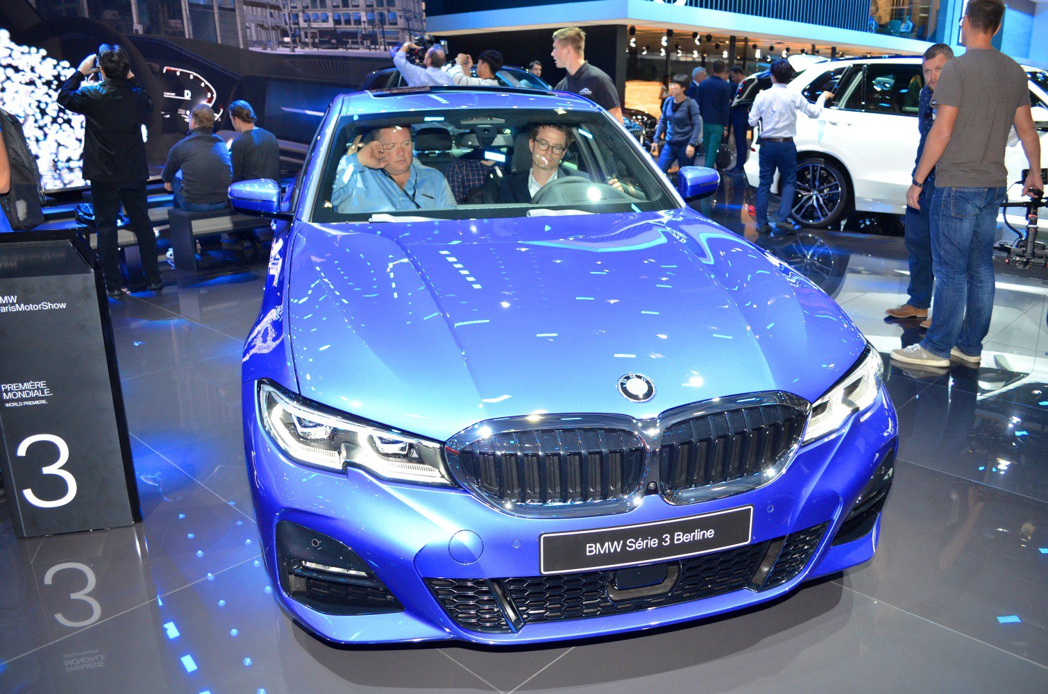 Front view with kidney grille and LED headlights on blue sedan