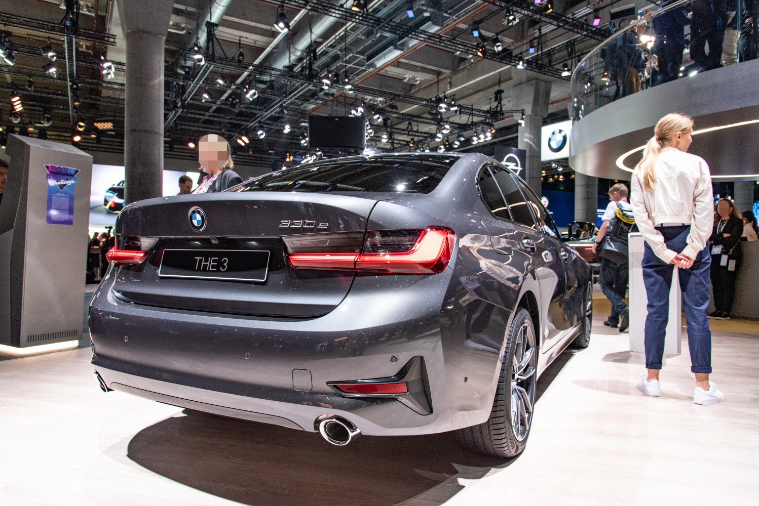 Rear of modern sedan with LED tail lights, exhaust pipe, and alloy wheels.