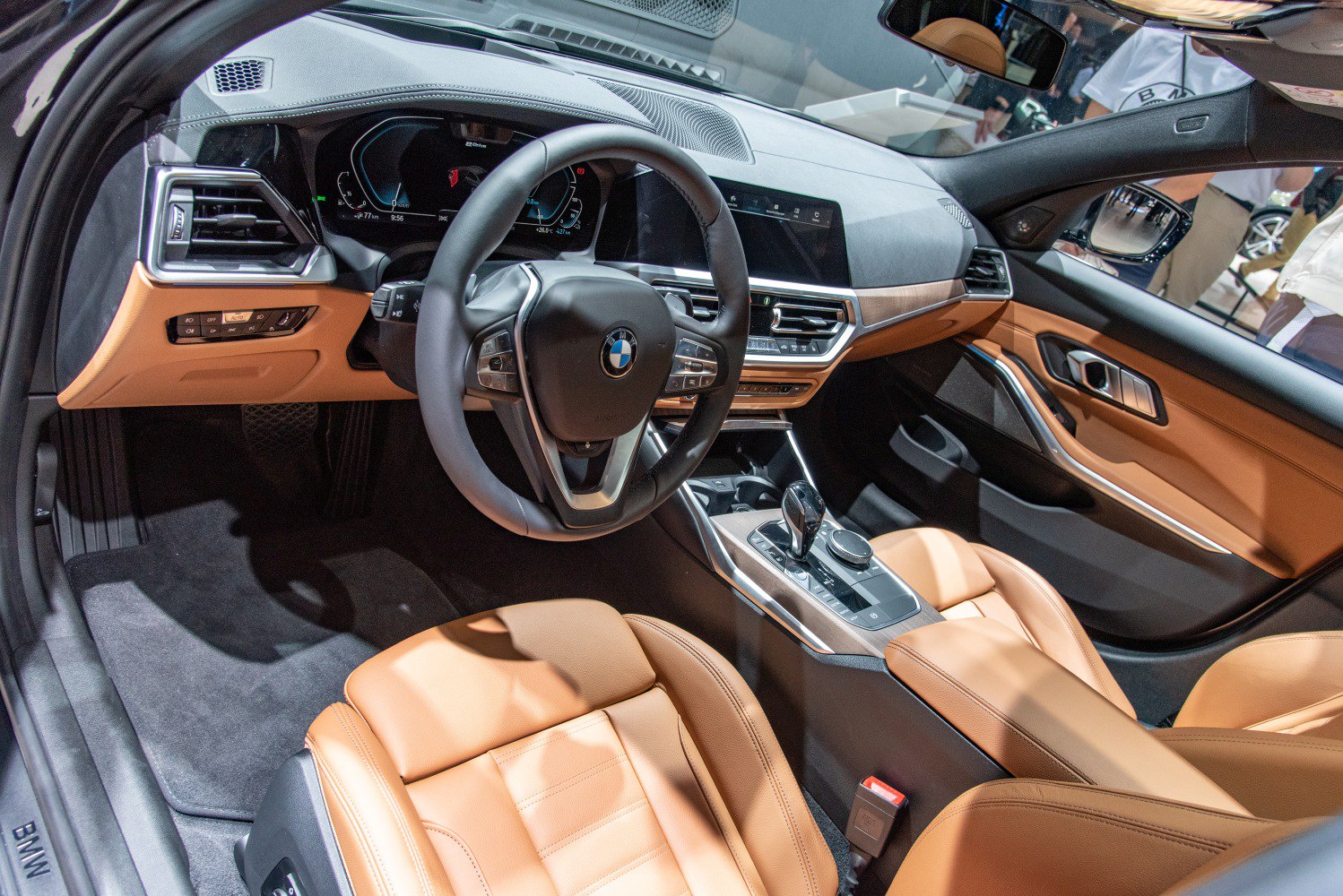 Advanced digital dashboard with tan leather seats and modern center console.