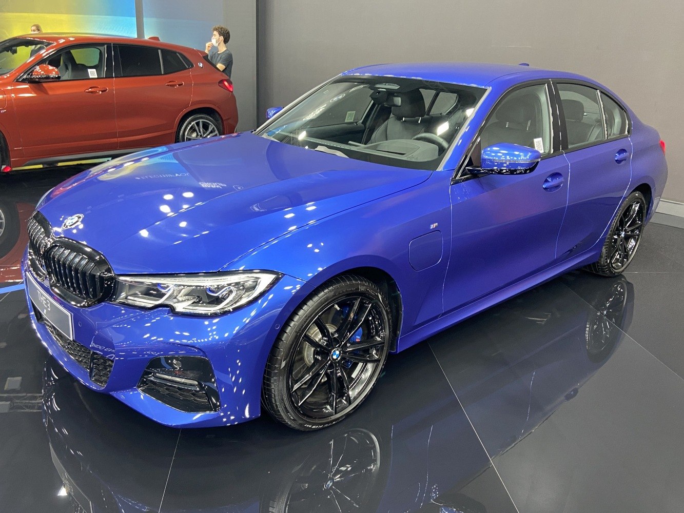 Electric blue sedan with black alloy wheels and LED headlights