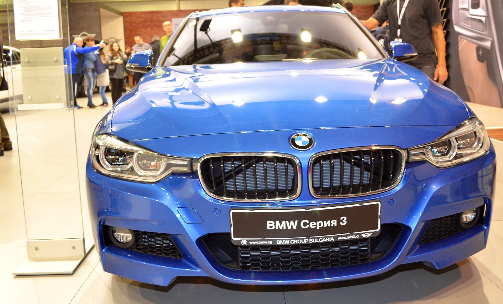BMW front kidney grille and LED headlights in blue sedan