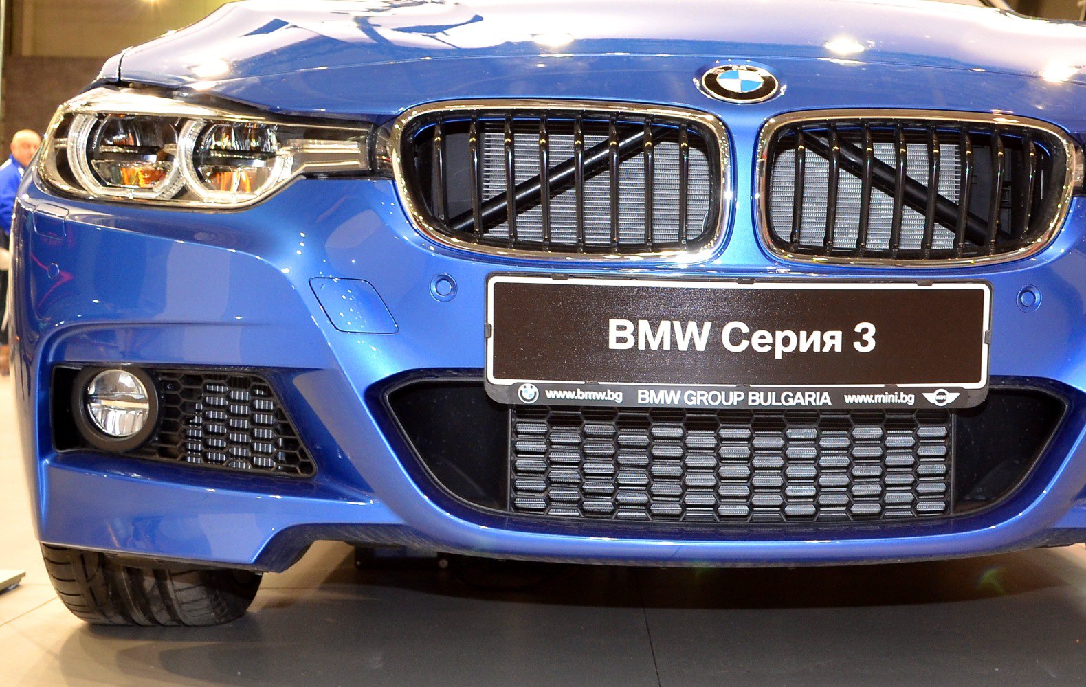 Close-up of front grille and headlights on a blue vehicle