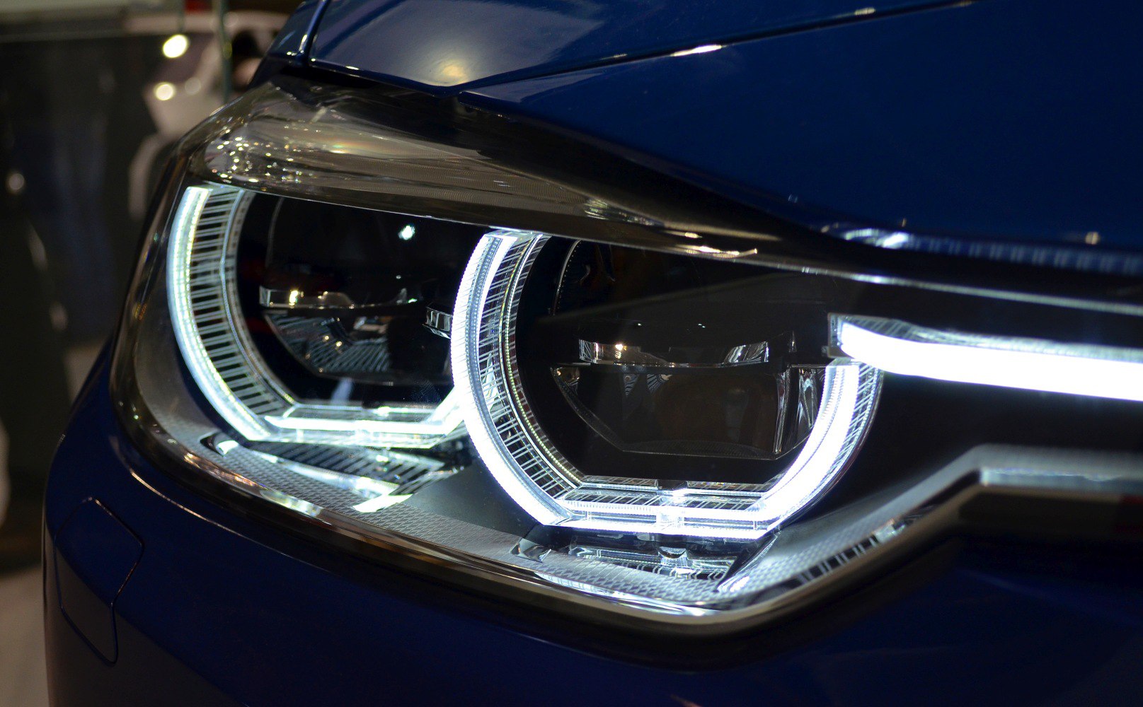Close-up of BMW F30 LCI dual-ring LED headlight with sharp LED strip
