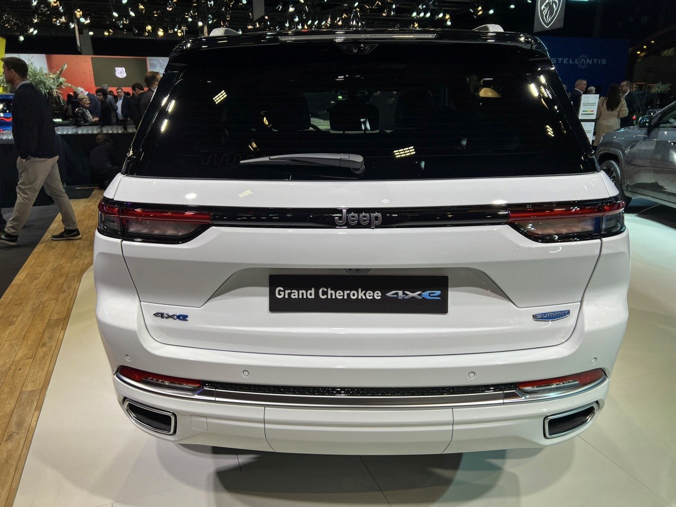 Rear of SUV with 4xe and Summit badges, sleek tail lights, and integrated exhausts