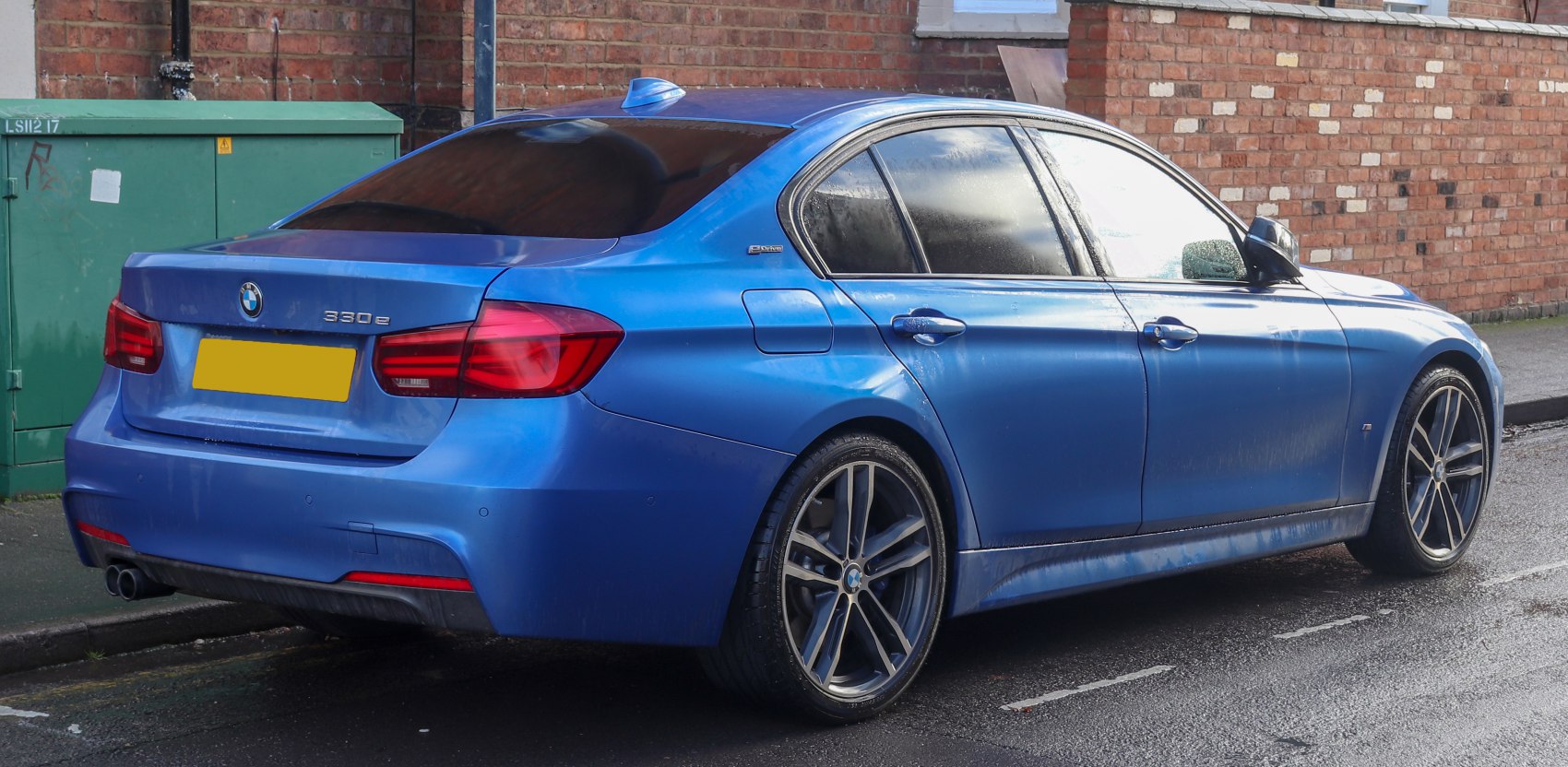 Rear and side view of a sedan with alloy wheels