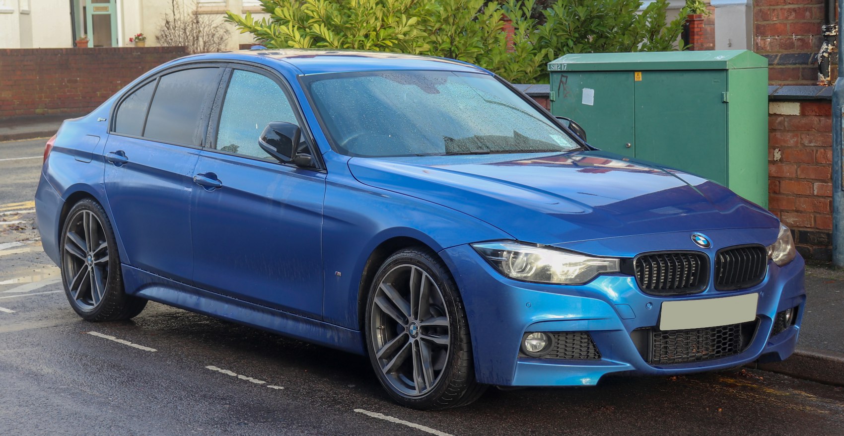 Blue modern sedan with LED headlights and sporty alloy wheels