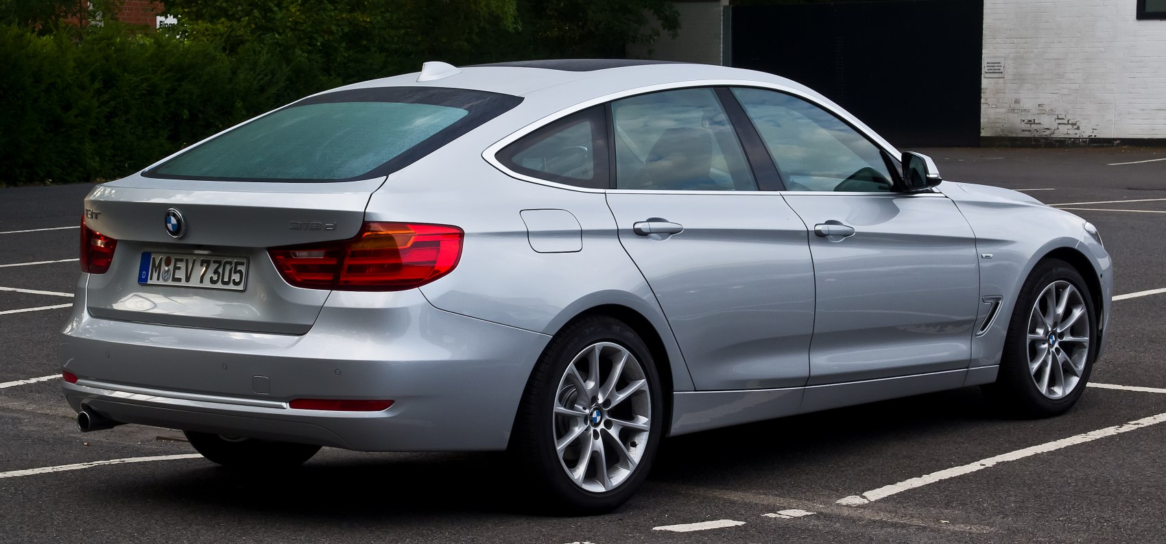Rear side view of a silver luxury hatchback with alloy wheels