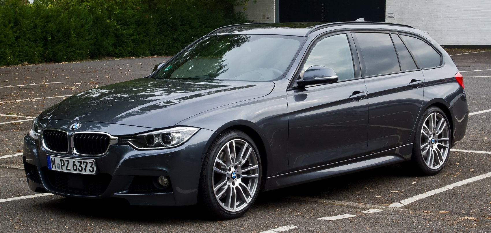Sporty station wagon exterior with multi-spoke wheels and sleek front design