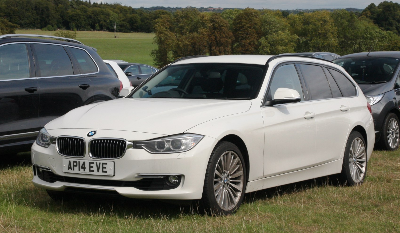 White front-side view of a BMW wagon with kidney grille and alloy wheels