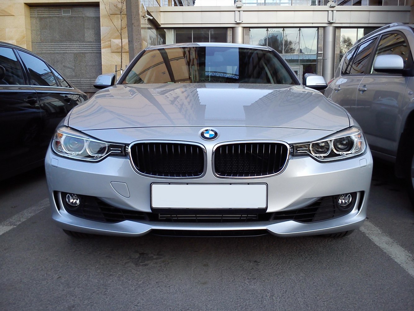 Front view showing kidney grille and dual round headlights of a sedan