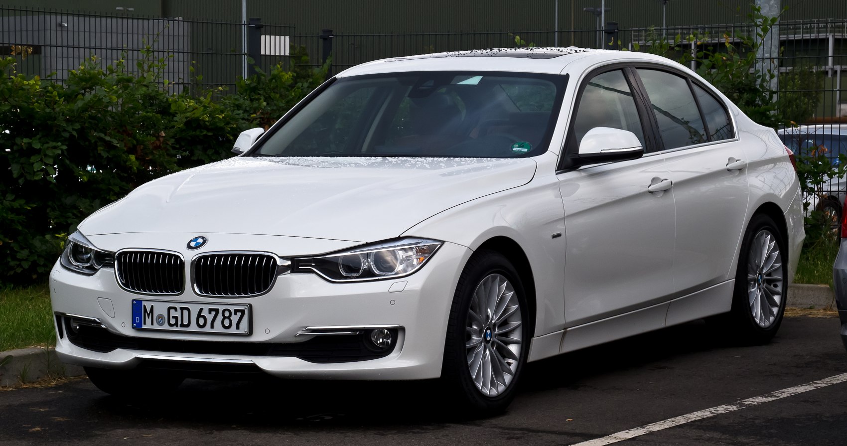 Front grille, headlights, and side profile of a sedan with alloy wheels