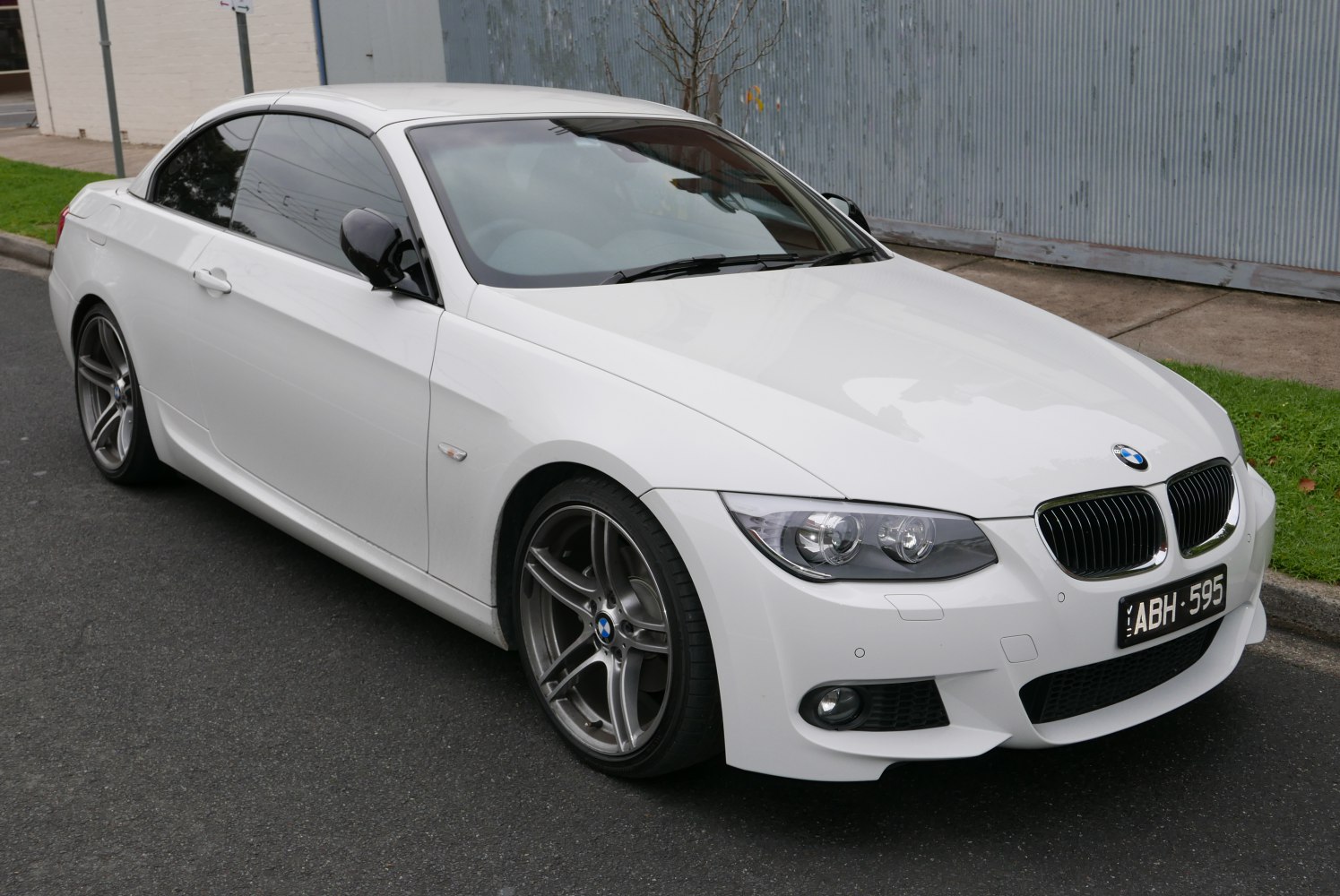 Front side view of white convertible with alloy wheels