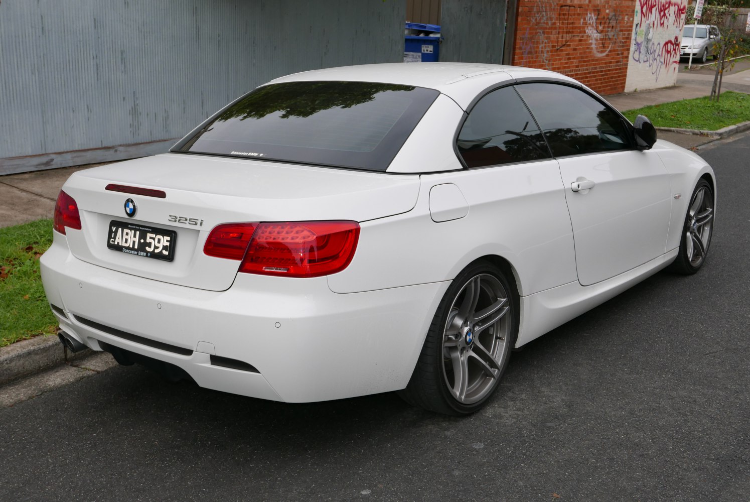 Rear view of convertible with coupe roof and distinct tail lights