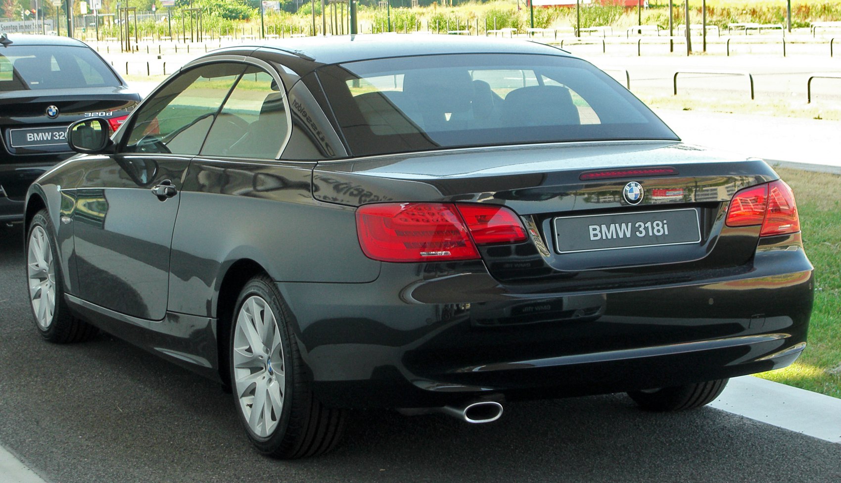 Rear view of convertible hardtop with distinct taillights and single exhaust