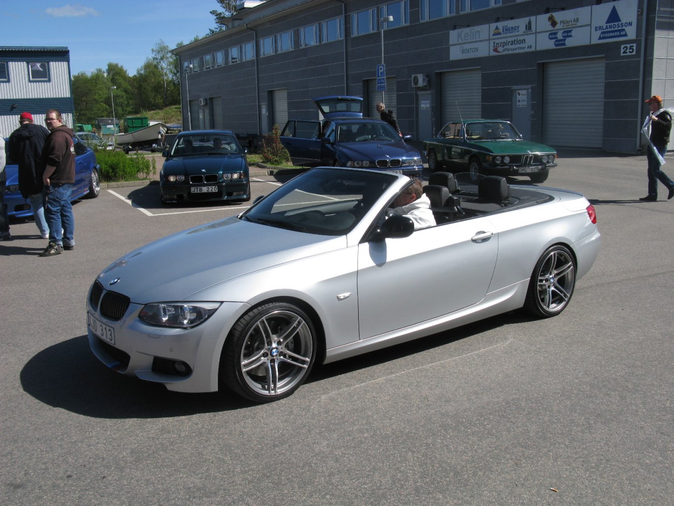 Silver convertible with open roof and sporty multi-spoke rims