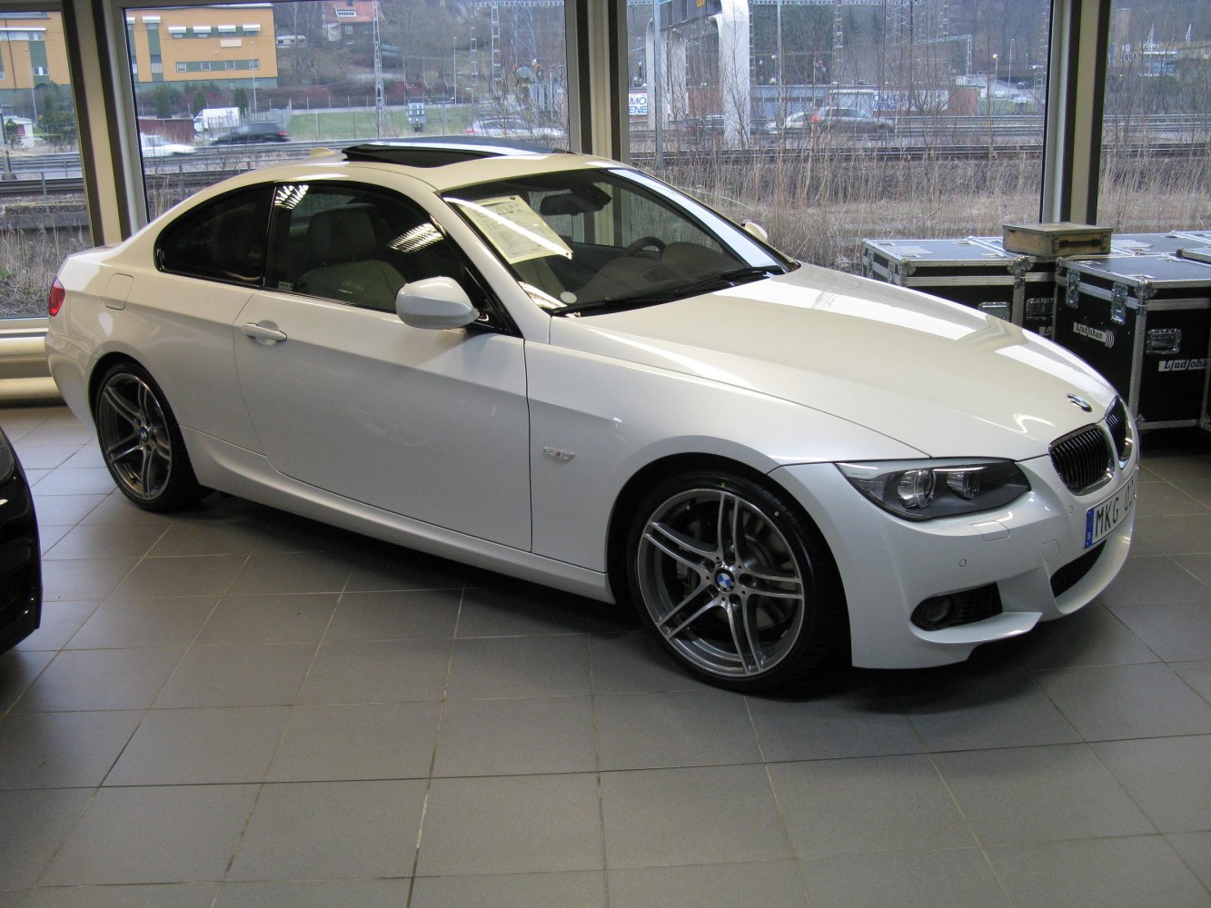 White coupe with facelift LED headlights and alloy wheels