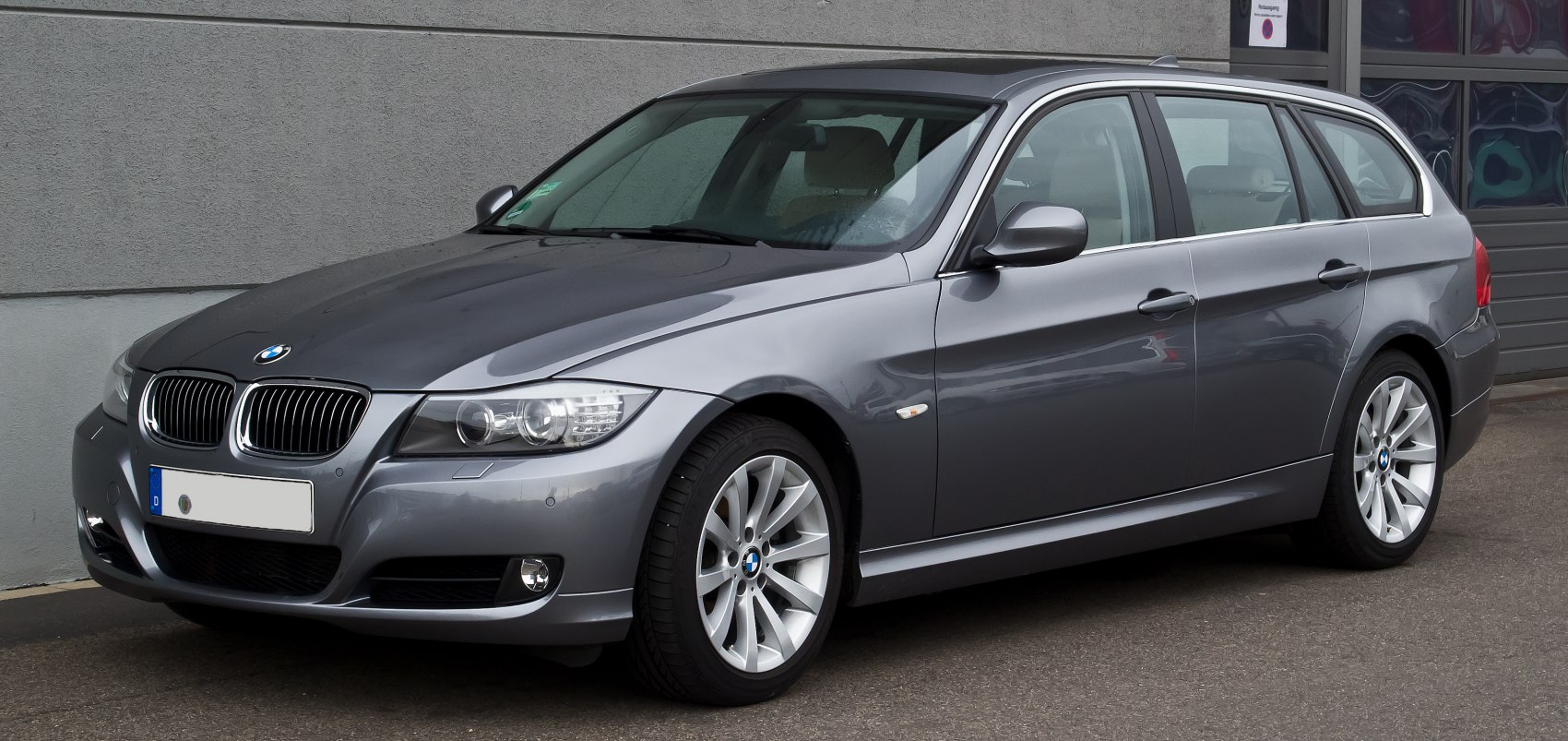 Front-side view of metallic gray station wagon with kidney grille and alloy wheels