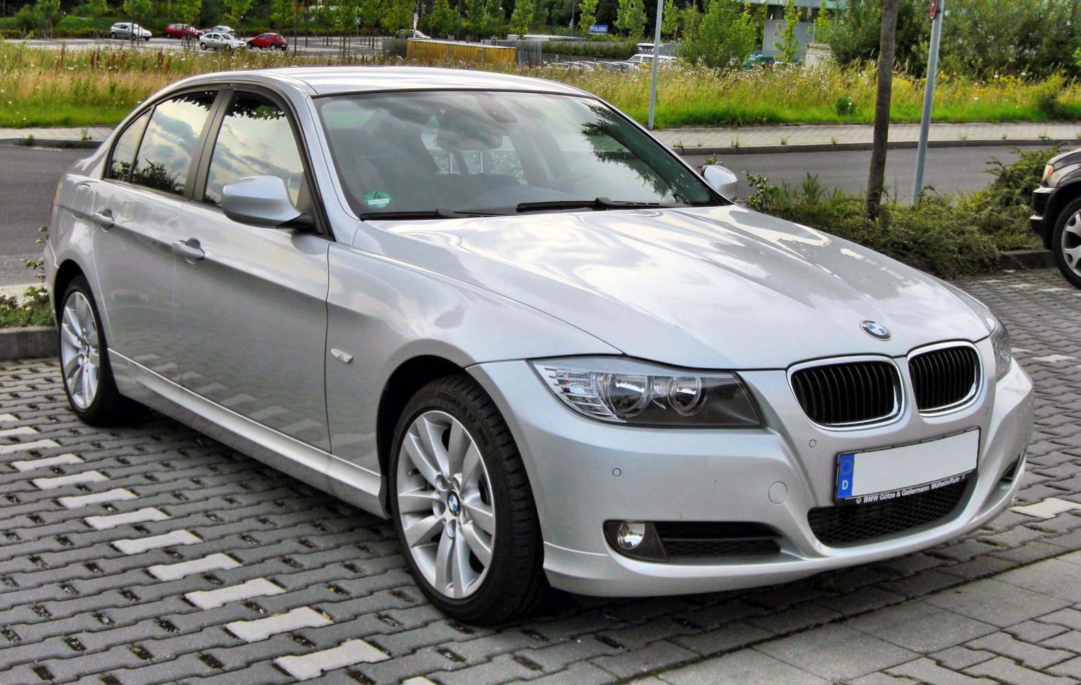 Silver sedan with kidney grille and alloy wheels in outdoor parking