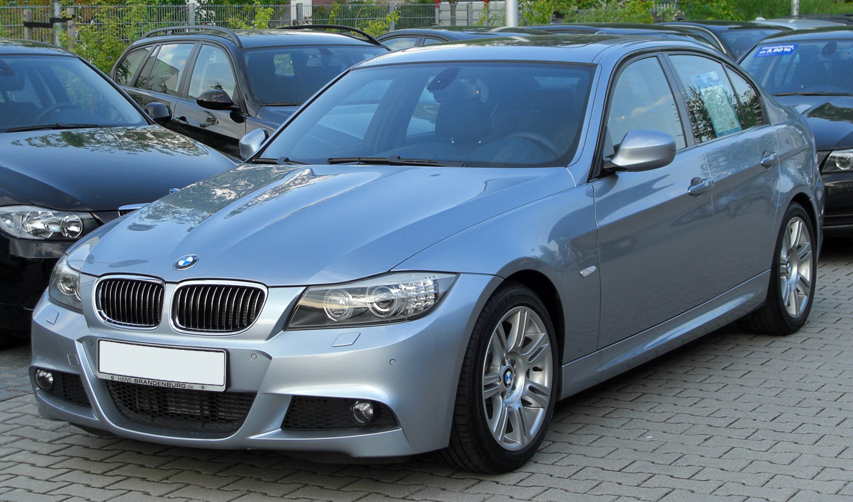 Front and side view of a sedan with kidney grille and dual headlights