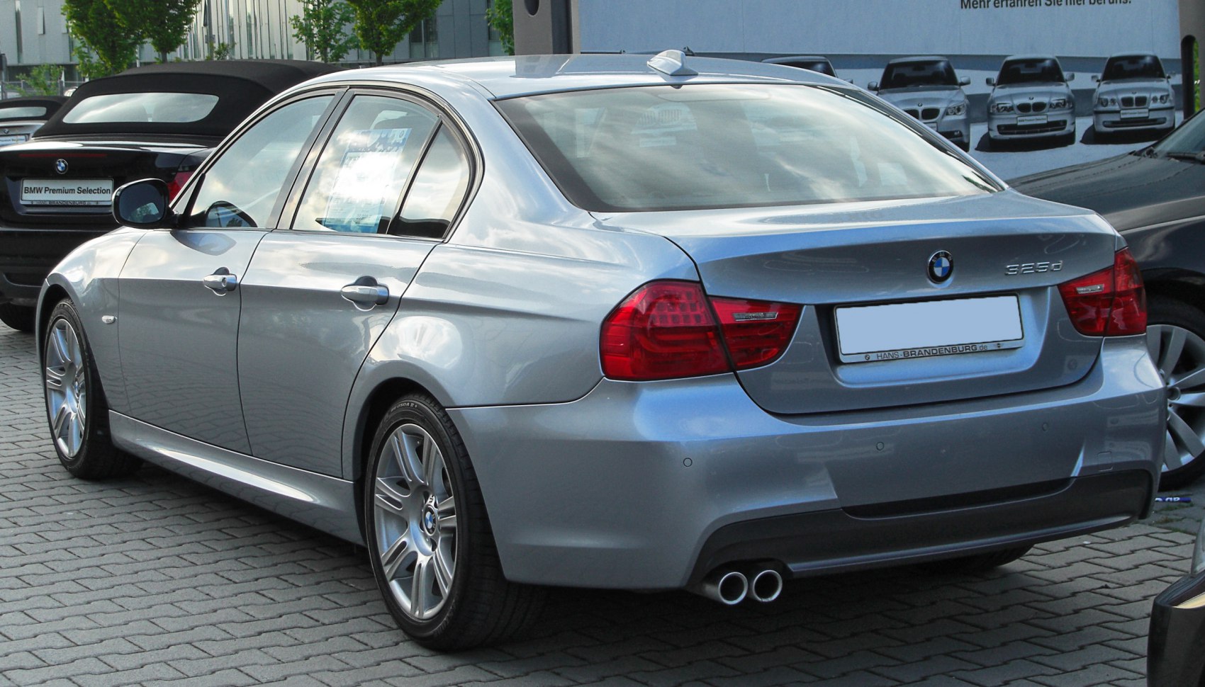 Silver sedan rear and side view with dual exhaust and distinct taillights