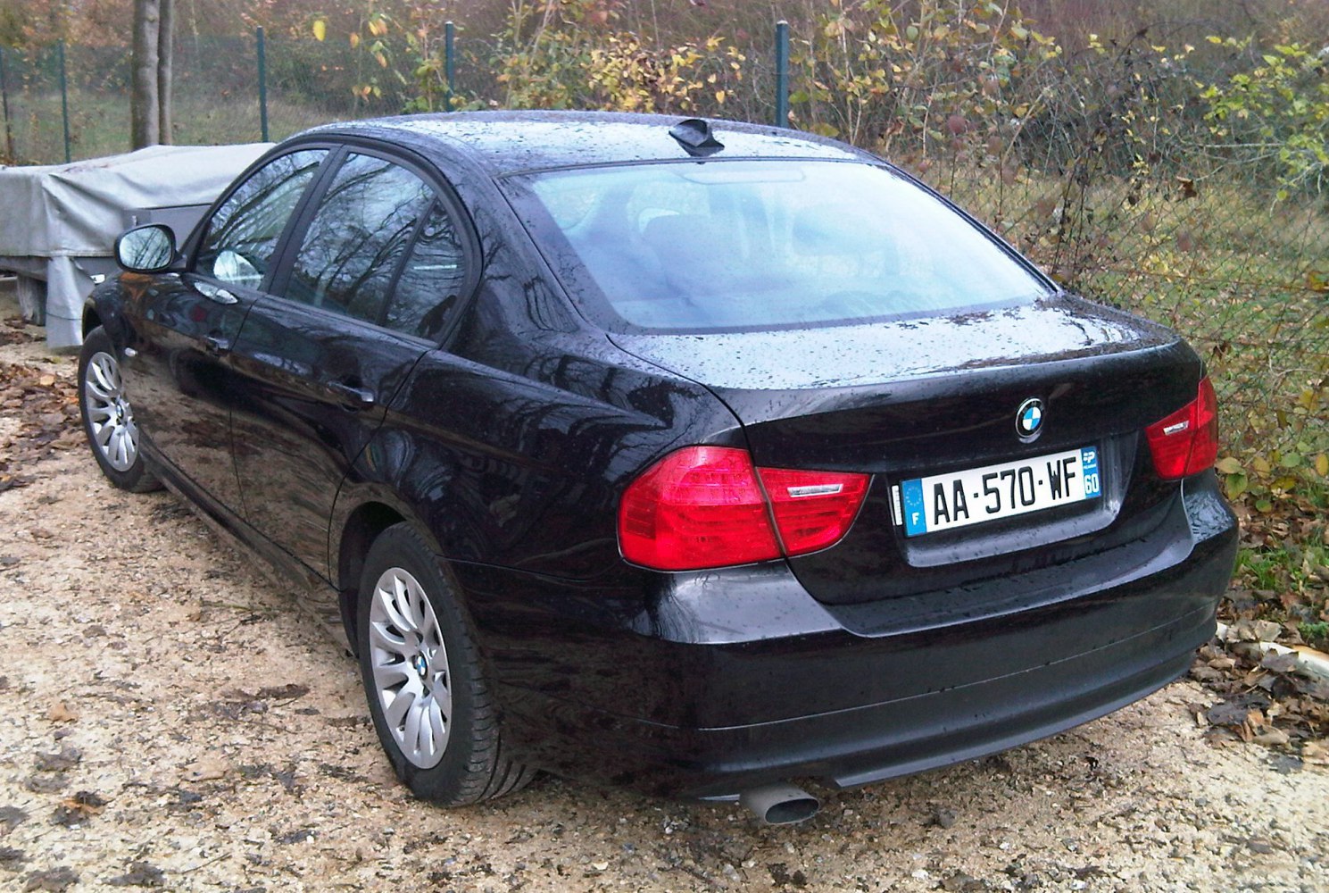 Facelifted sedan rear view with distinctive taillights and single exhaust pipe