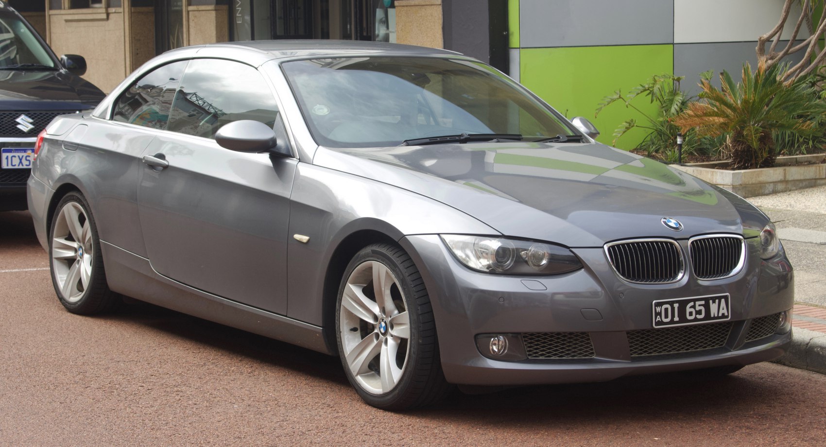 Silver convertible coupe with alloy wheels and distinctive headlights